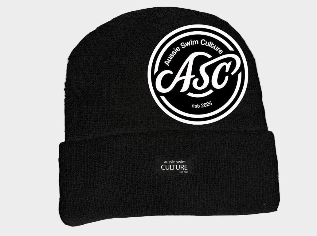 Black beanie with white logo on a gray background