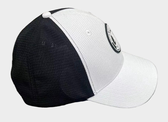 Black and white cap with a logo on a gray surface