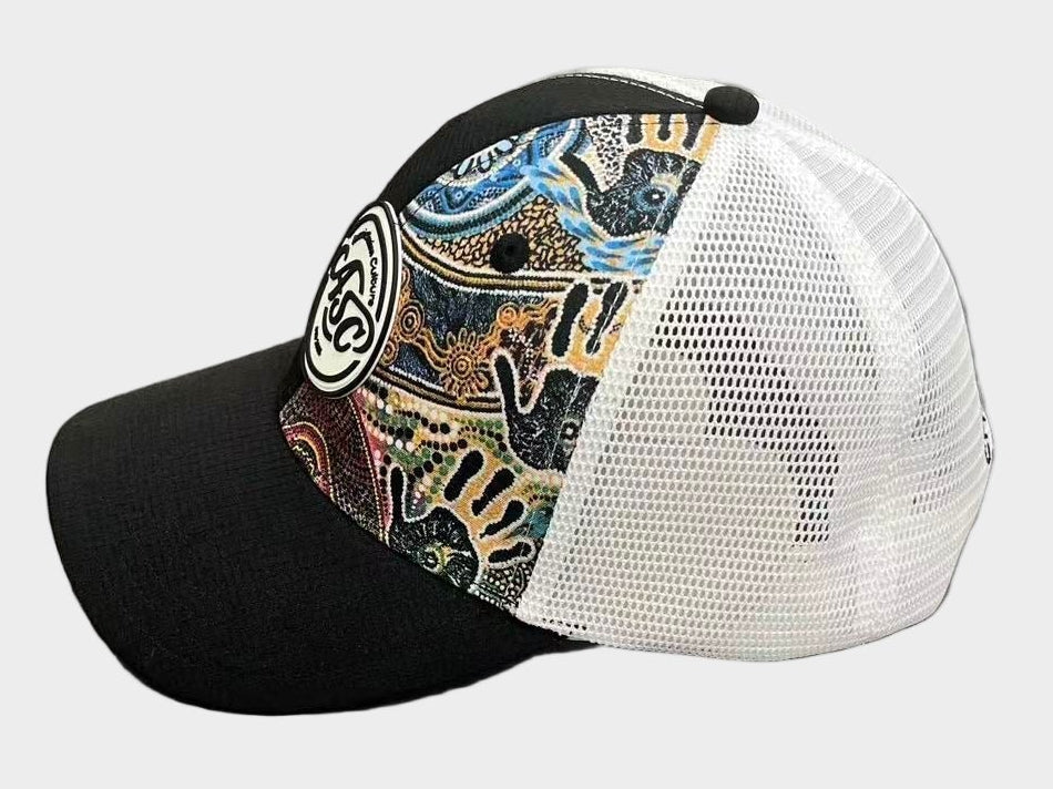 Colorful patterned cap with black and white sides on a gray surface
