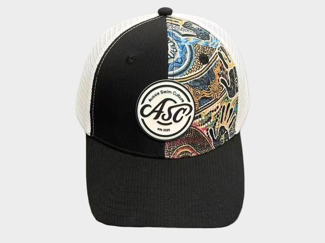 Black and white cap with a colorful pattern on a gray surface