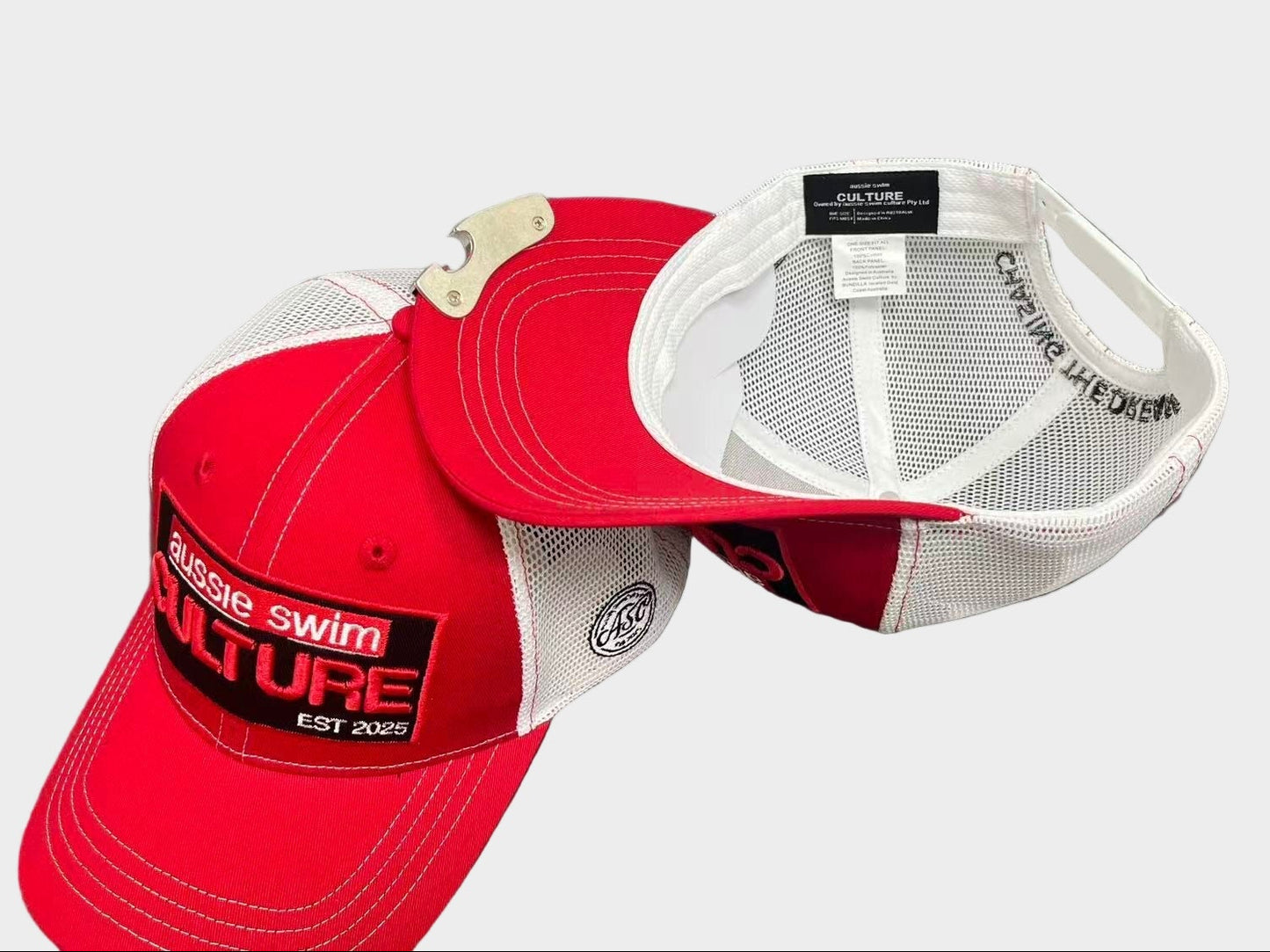 Red and white cap with visible branding on a gray background