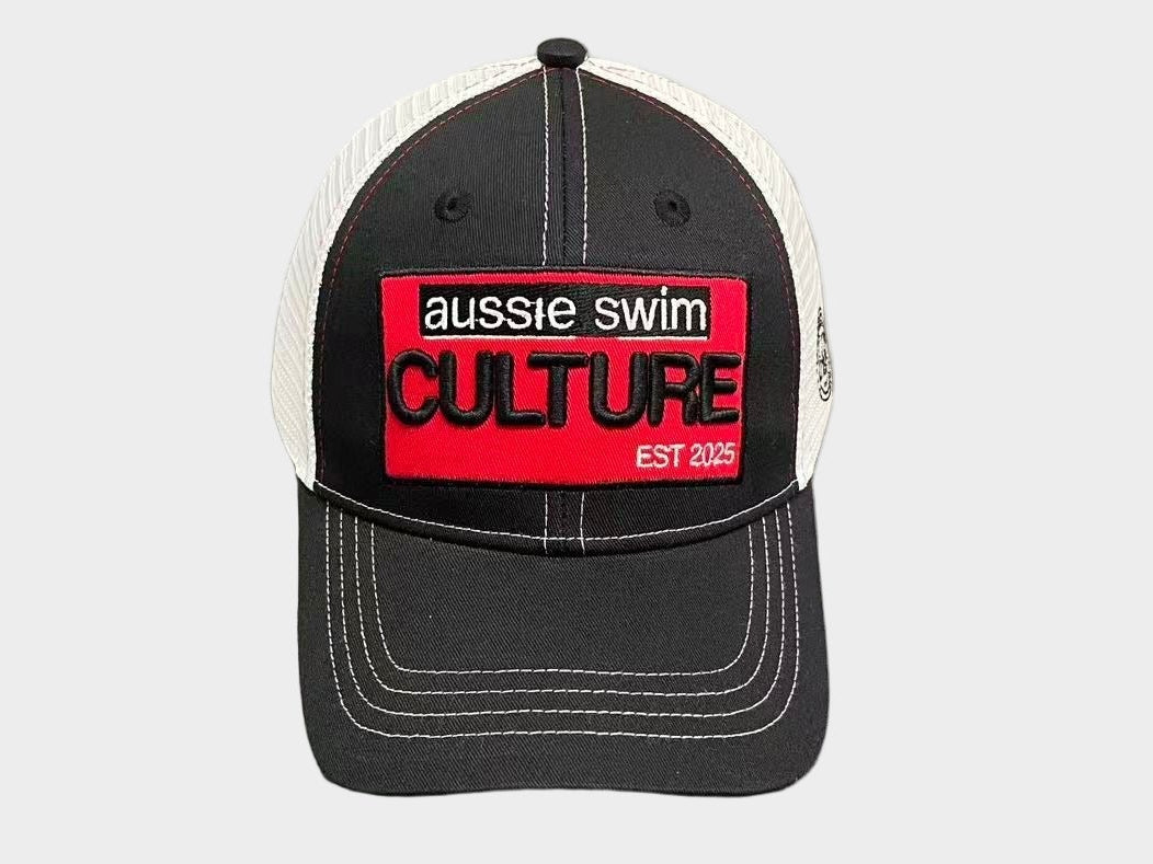 Black and white cap with a red logo on a gray surface