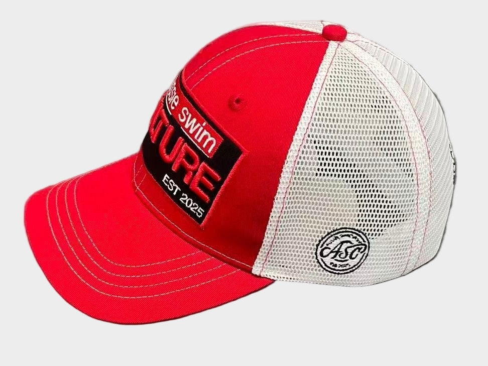 Red and white cap with branding on a gray surface