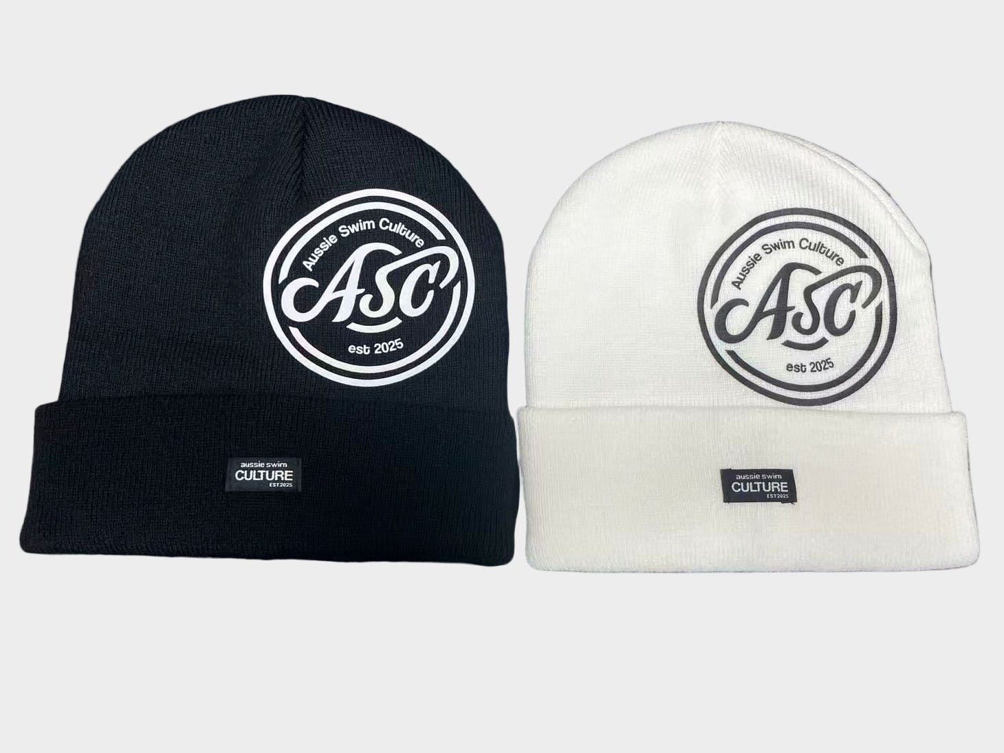 Black and white beanie hats with a logo on a gray background