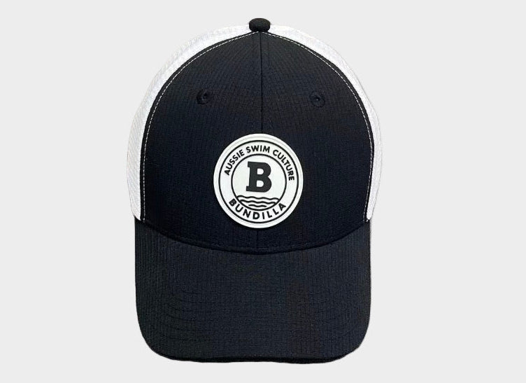 Black and white cap with a logo on a gray surface
