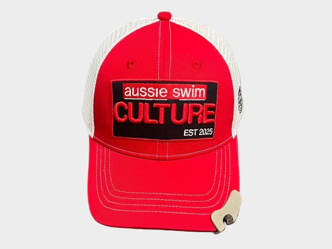 Red and white cap with 'aussie swim Culture' text on a gray surface